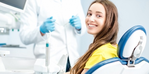 Smiling woman enjoying dental patient amenities