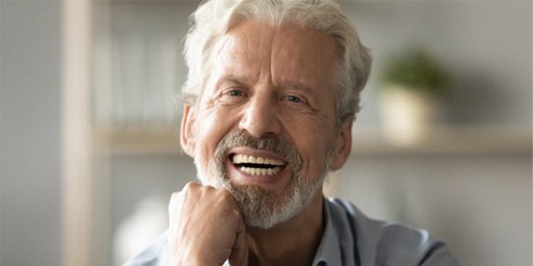 man smiling with dentures
