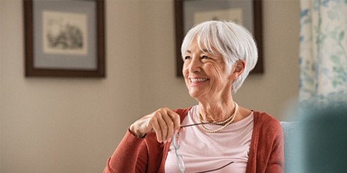woman smiling while reading book