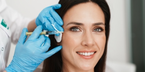 Woman receiving Botox injections around eyes