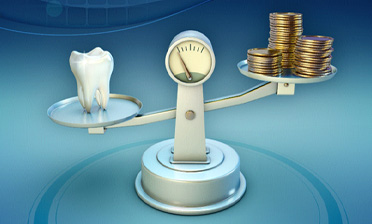 Tooth and coins on balance scale