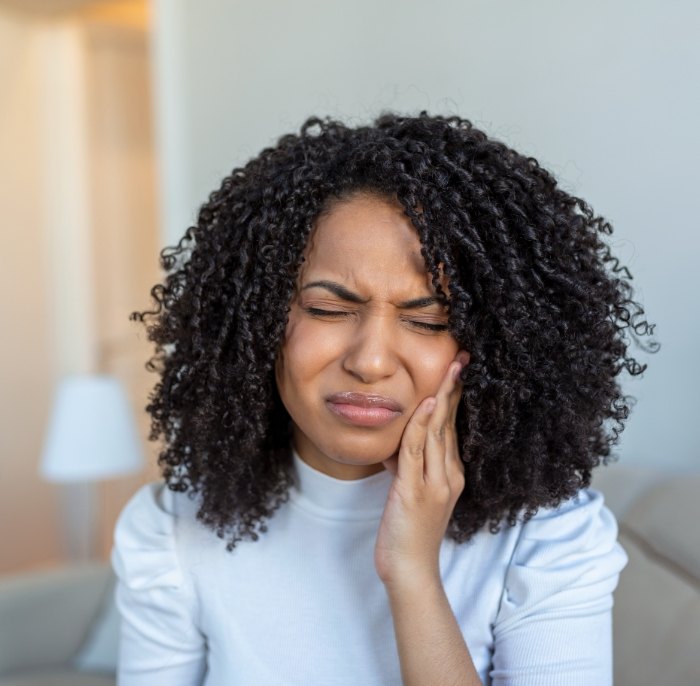 Woman in pain before emergency dentistry treatment