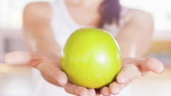 Person holding an apple
