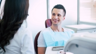 Dentist providing dental implant restoration