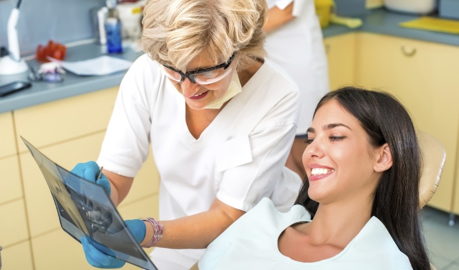 Dentist talking to dental patient
