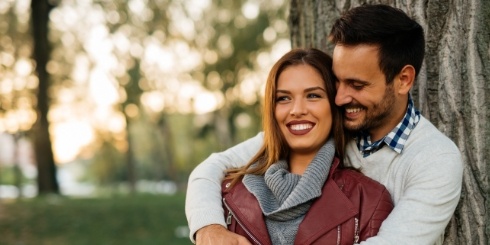 Smiling man and woman outdoors