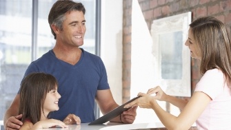 Dental team member and patient discussing payment options