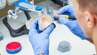 Dental technician making dentures