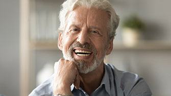 Man smiling and wearing dentures