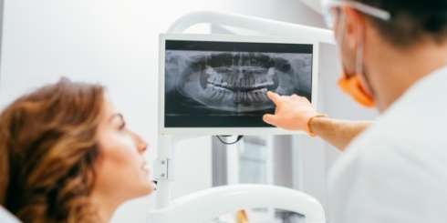 Dentist and dental patient looking at digital x-rays