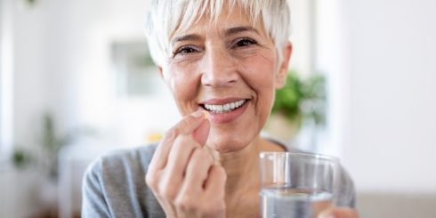Woman taking oral conscious sedation dentistry pill