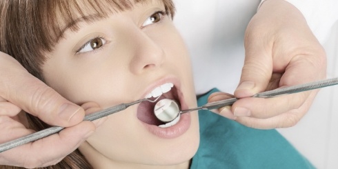Dentist providing gum charting during gum disease treatment visit