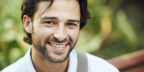 Man sharing flawless smile after full mouth reconstruction