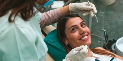 Dental patient smiling during preventive dentistry checkup