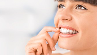Woman inserting her Invisalign in Mount Pleasant trays