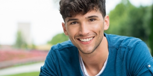 Man sharing flawless smile after Invisalign treatment