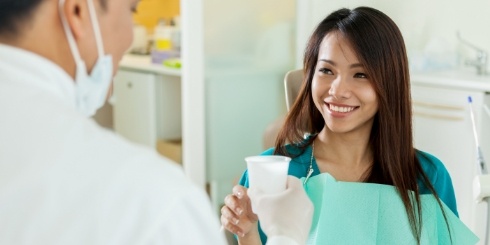 Woman talking to dentist after root canal treatment
